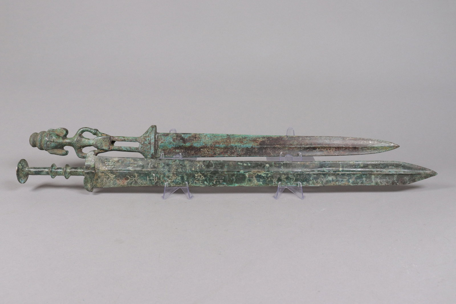 2 Chinese bronze swords: 2 Chinese fine bronze swords. Longest L: 23" x W: 2.1."