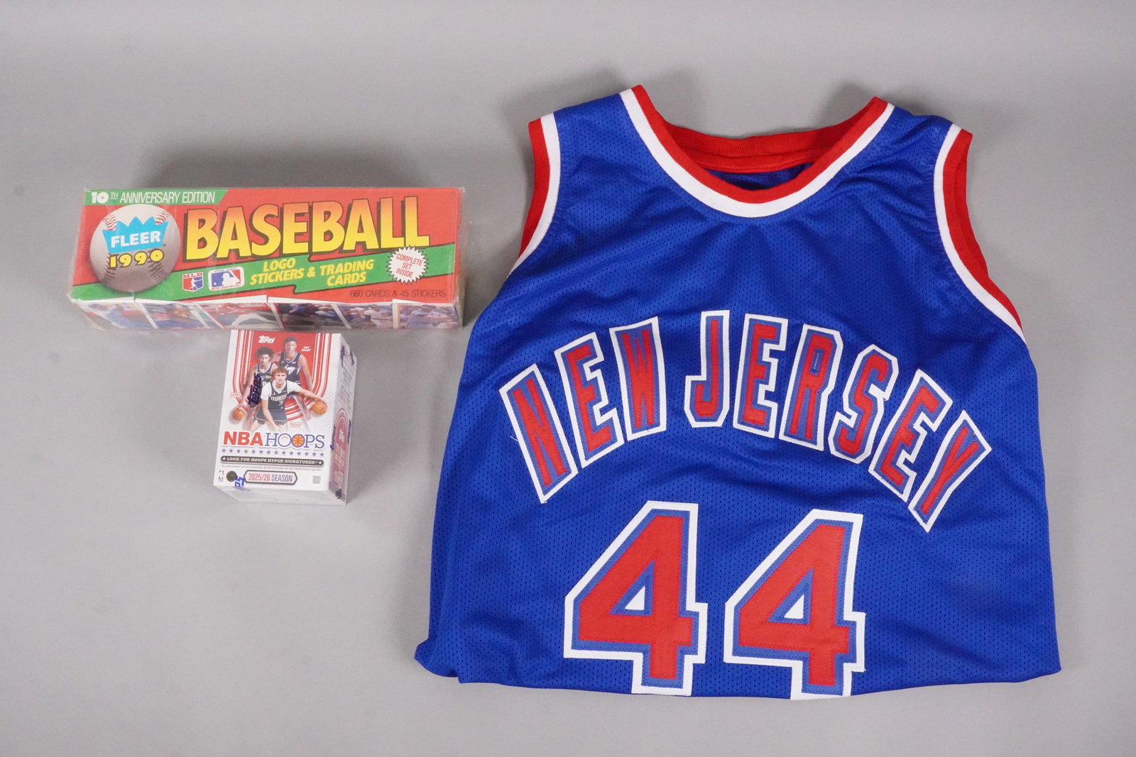 A signed basketball jersey and cards: A signed basketball jersey and sports card, sealed.