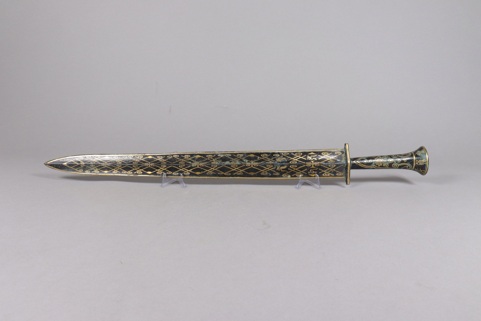 Chinese gilted bronze carved sword: Chinese gilted bronze carved sword. L: 25.5" x W: 3."