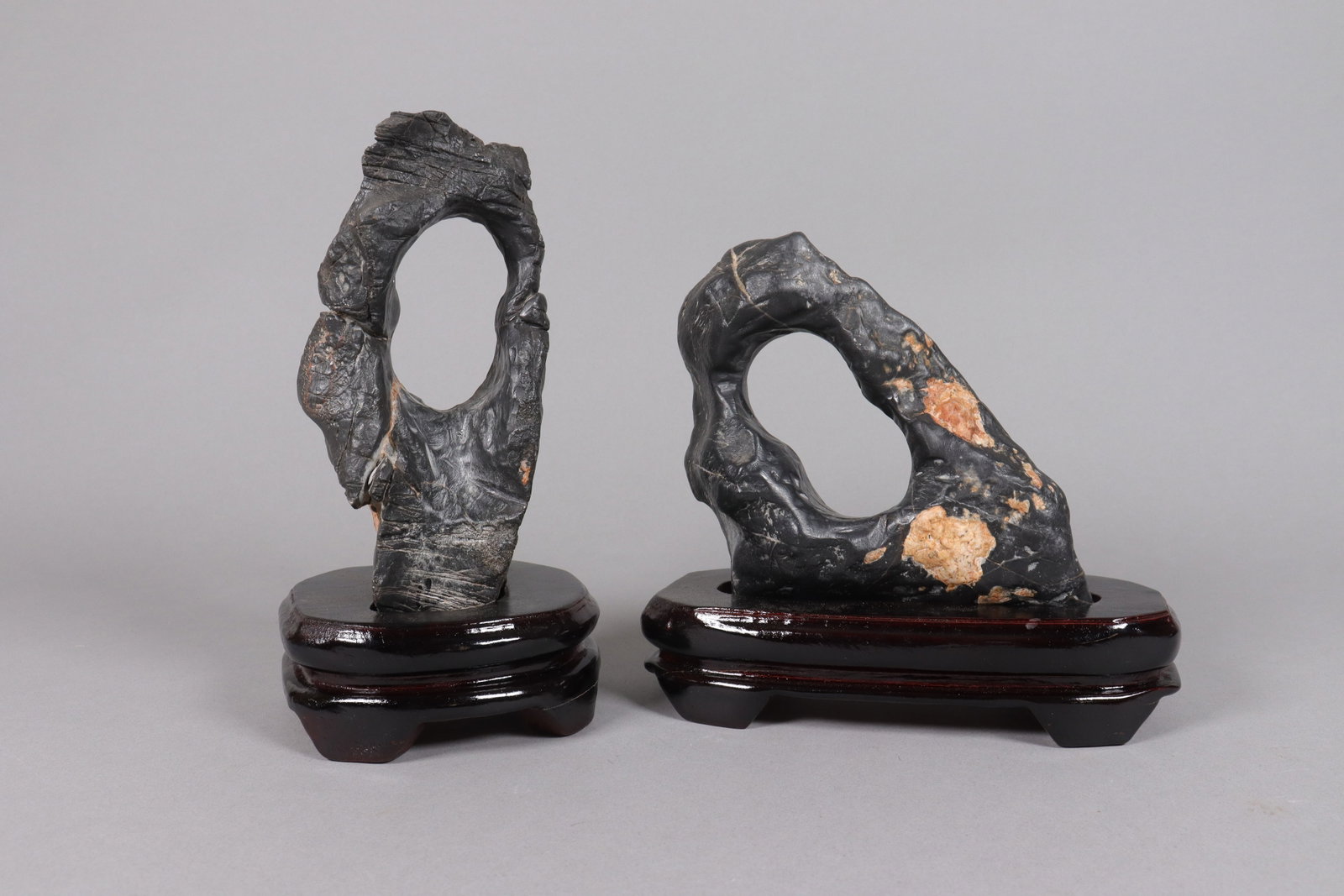 2 Chinese scholar stones on stand: 2 Chinese scholar stones on wooden stand. Heavy in weight.