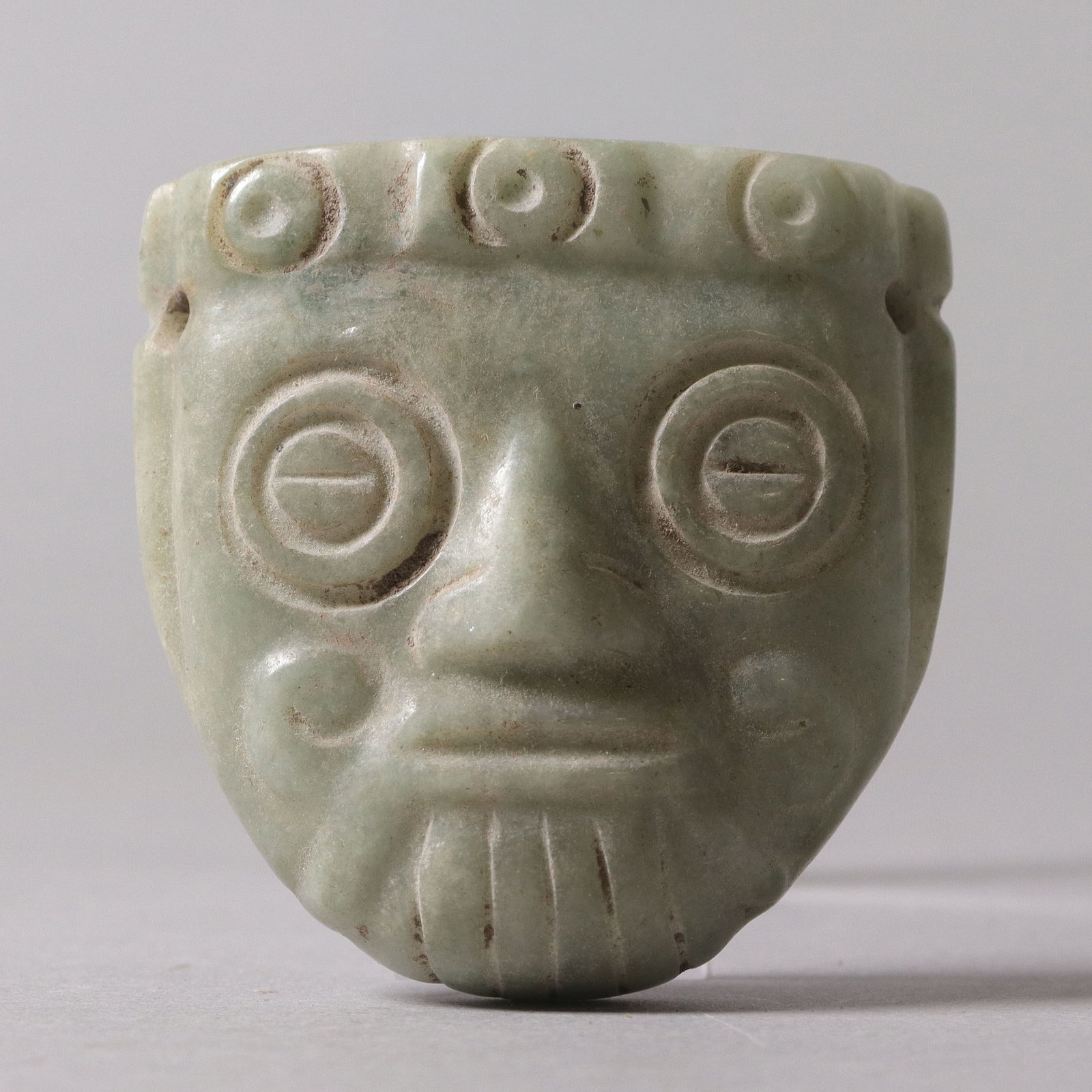 Important Pre-Columbian mask celt: Important Pre-Columbian fine carved jade stone mask celt. From a major estate. H: 2.3" x W: 2."