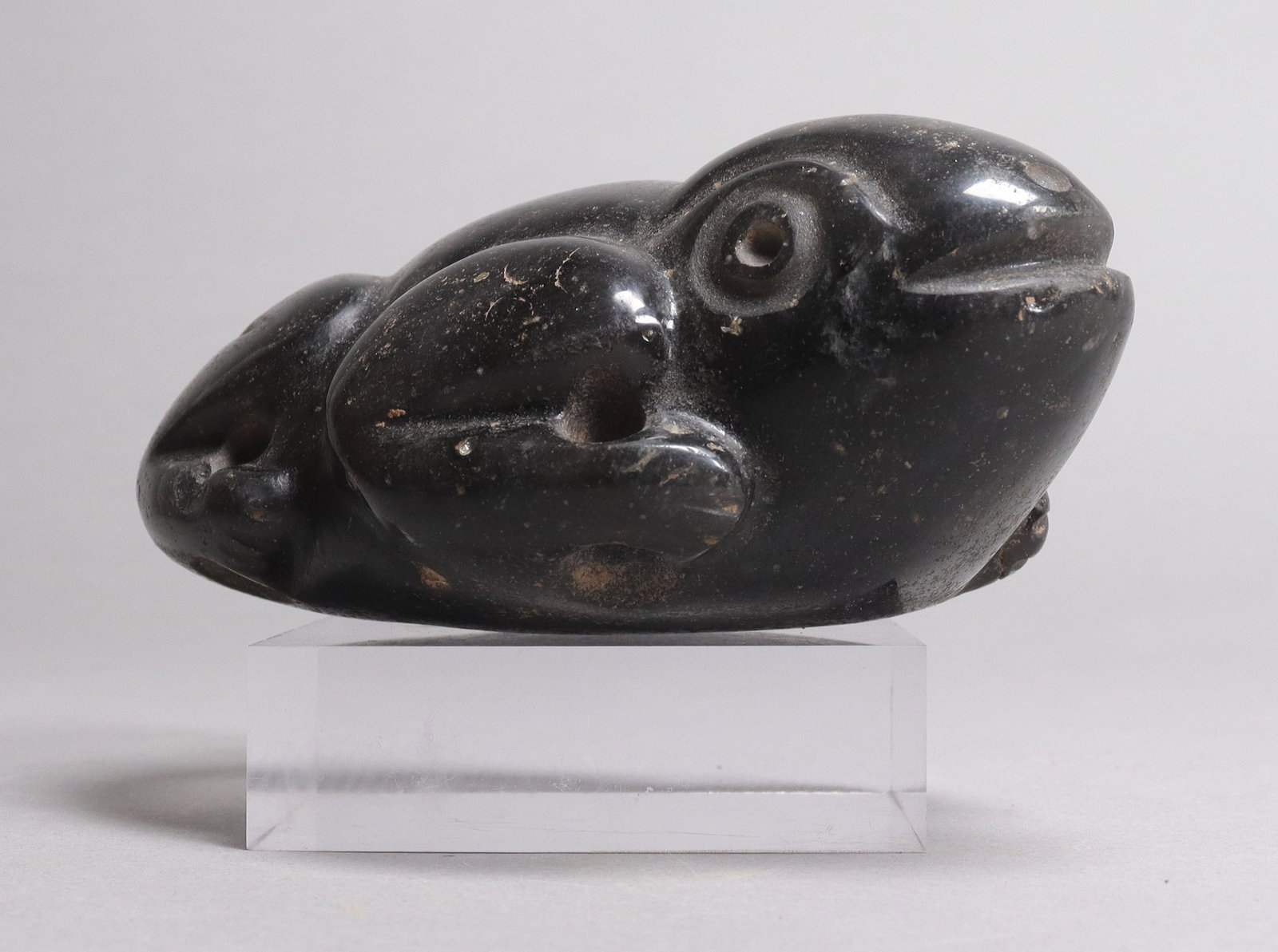 Pre-Columbian carved stone frog form: Pre-Columbian carved stone frog form. H: 2" x W: 5.25."