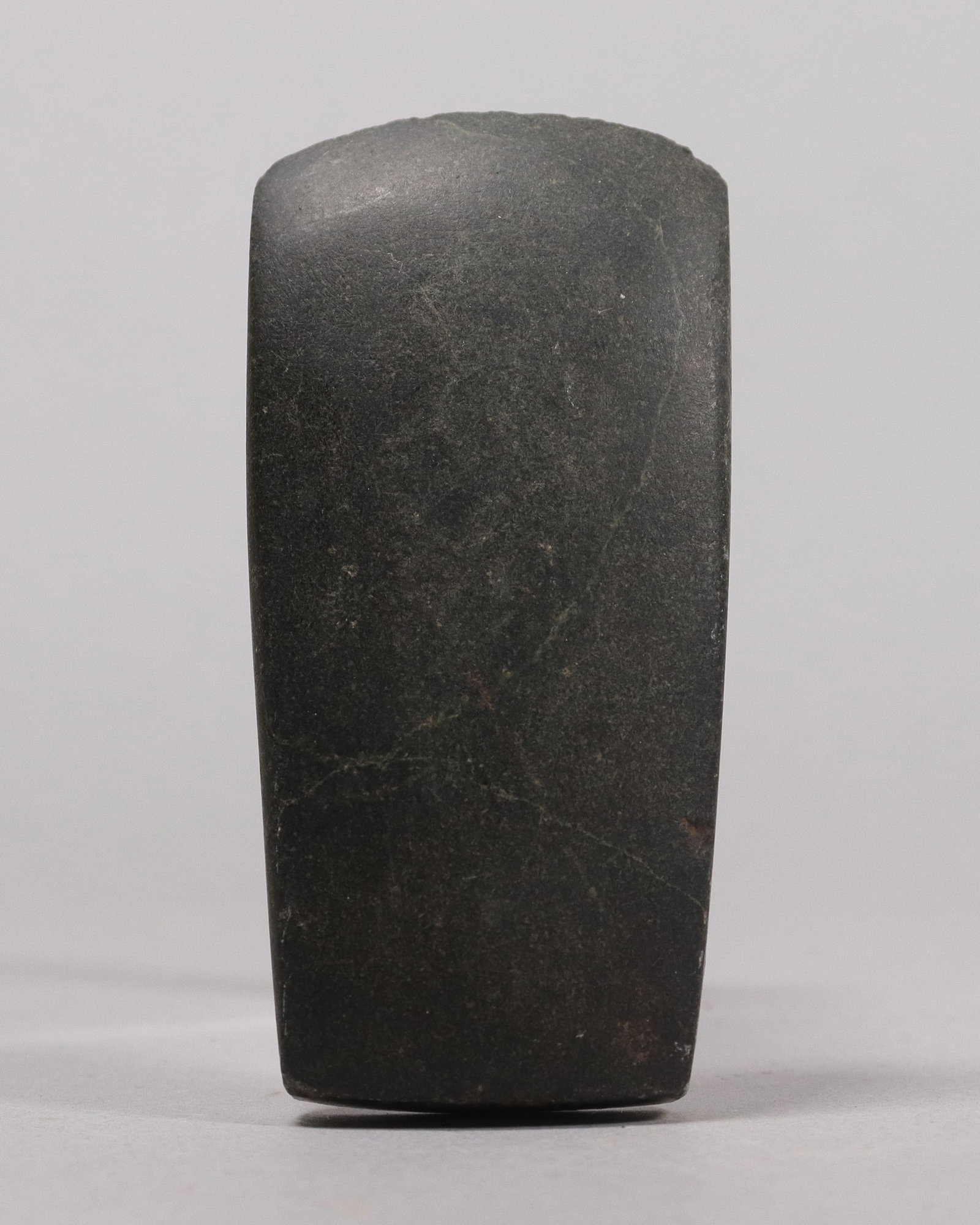 Pre-Columbian carved stone tool: Pre-Columbian carved stone tool. H: 3.5" x W: 1.5."