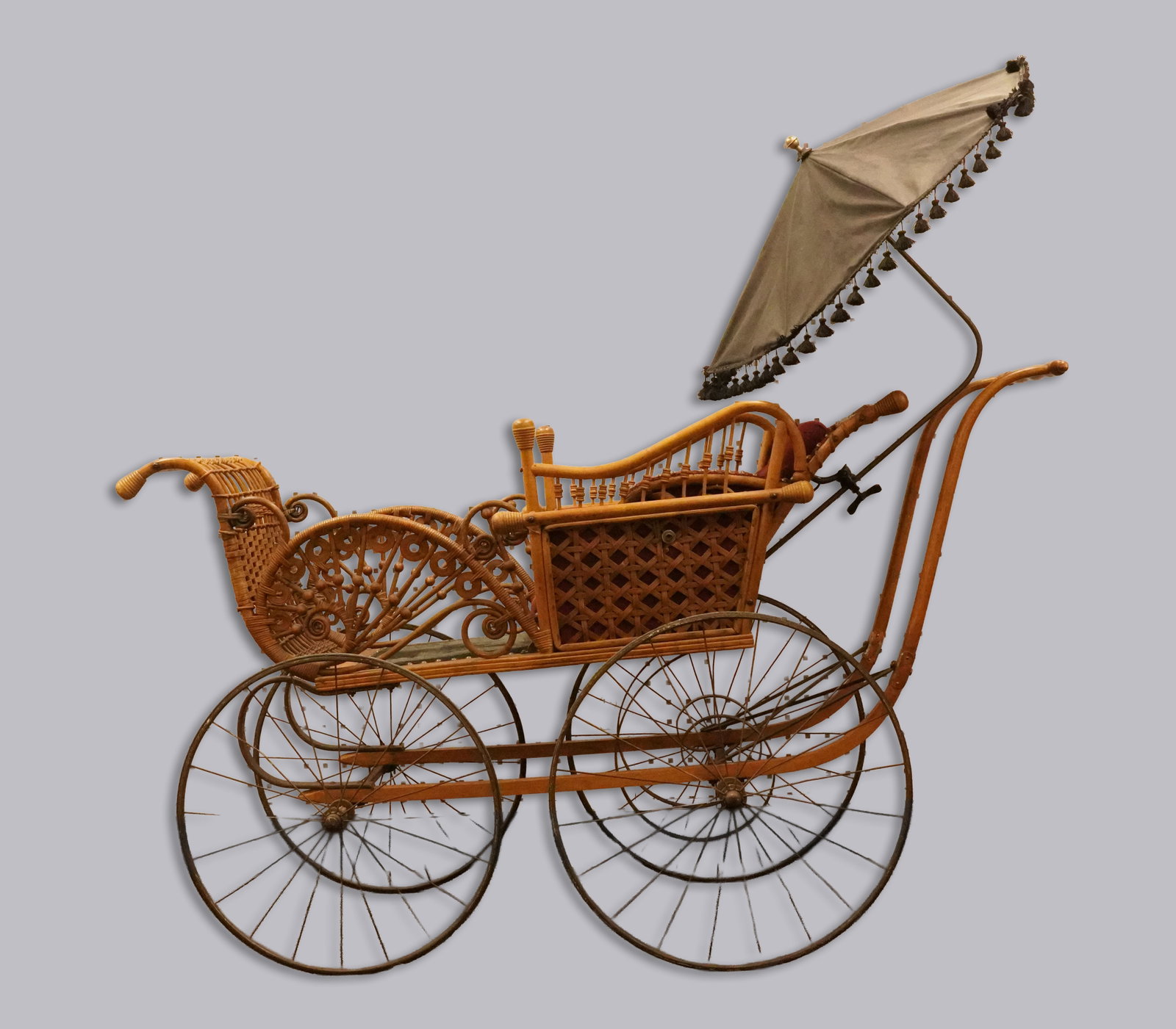 Antique Victorian era baby wagon: Antique Victorian era wickered baby wagon. Works in good condition. H: 53" x W: 59."