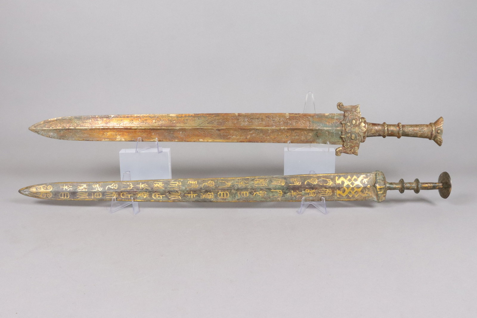 2 Chinese gilted bronze sword: 2 Chinese fine gilted bronze sword. L: 3.25" x W: 25."