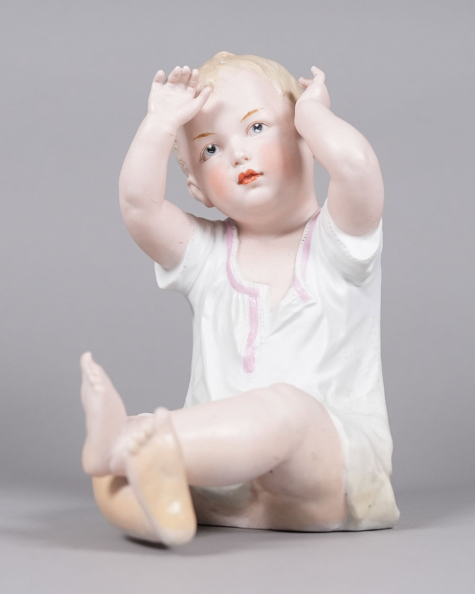 A vintage porcelain figurine: A vintage porcelain figurine. H: 9.3" x W: 7.7."
