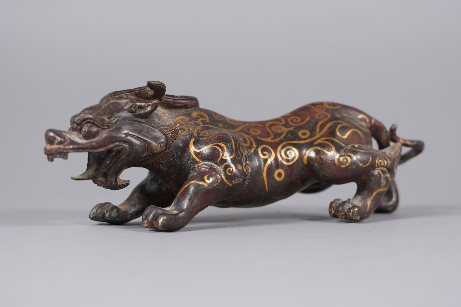 Chinese fine gilted bronze beast: Chinese fine gilted bronze carved beast. H: 3" x L: 10."