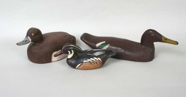 Chas. Moore Duck Decoy: Charles Moore duck decoy inset with glass eyes, painted, and signed; together with two more decoys, one with glass eyes, both simply painted and unsigned. Chas. Moore 4 1/2"H. 10"L. Duck with yellow g