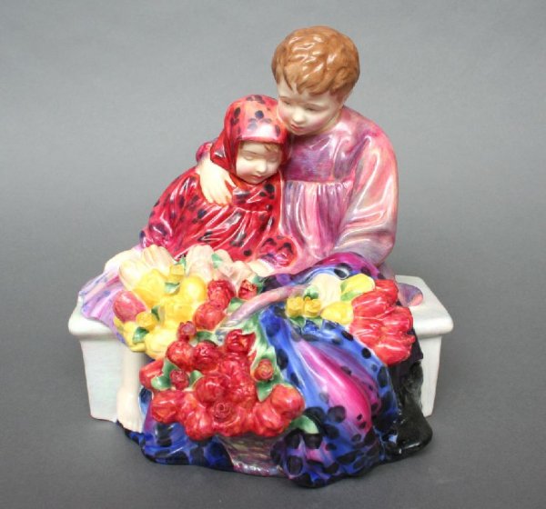 Royal Doulton Flower Sellers Children: Royal Doulton, England, Flower Sellers Children, HN 1342, modeled as two children sitting on a bench, together with a lush bouquet of flowers, painted in polychrome enamels, stamped on the base in gre