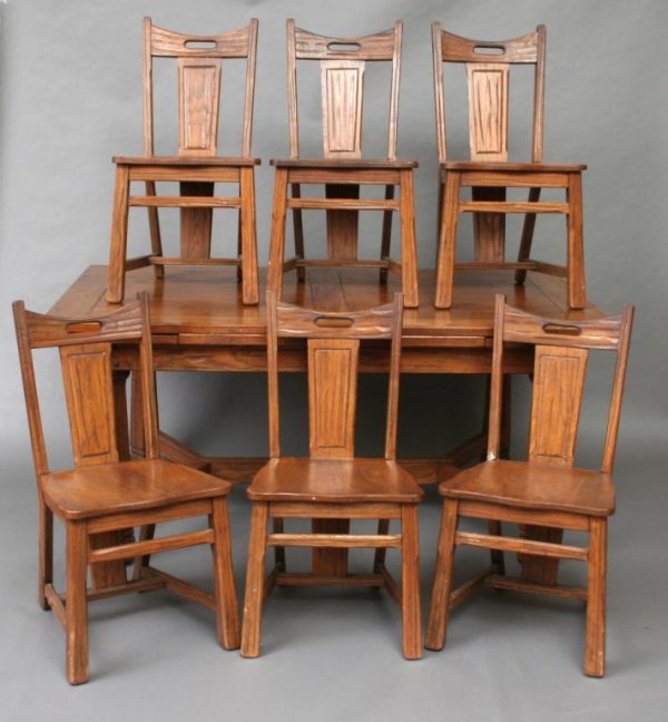 Romweber Or Brandt Style Ranch Oak Dining Suite: Attributed to Romweber or Brandt, comprising a refectory dining table and six side chars, each with flared legs, unsigned. Table 29 1/2"H. 66"W (closed). 40"D. Leaf 15 3/4"W. Chair 34"H. 17 1/2"W. 16"