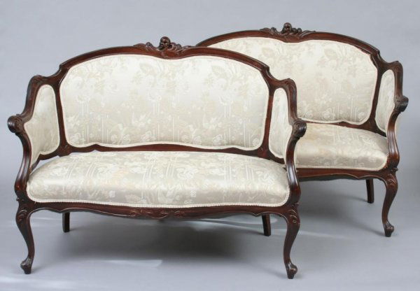 Pair Continental Art Nouveau Settees or Loveseats: Early 20th century, each with scroll carved frames raised on scrolled legs terminating in pad feet. 38"H. 49"W. 30"D. 17 1/2"H (seat). Condition: some light wear and imperfections, generally good.