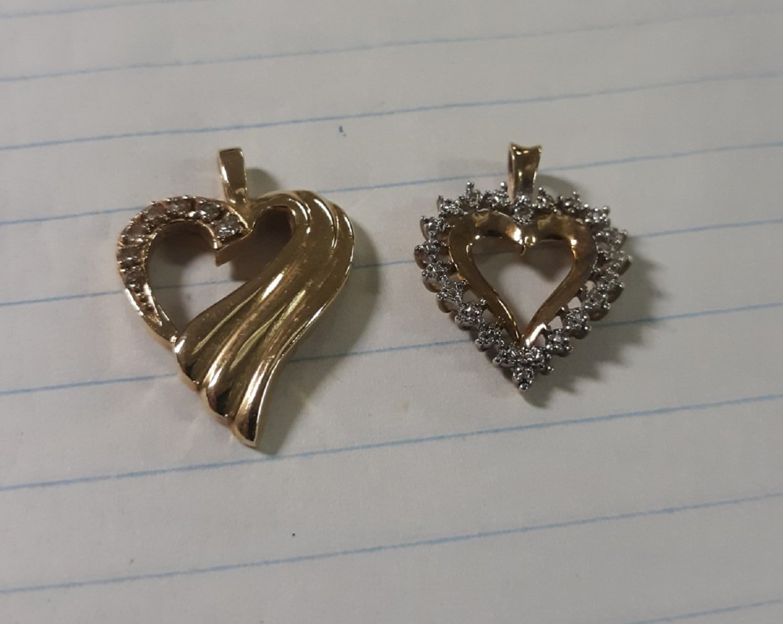Pair of Gold heart Pendants Diamonds: beautiful pair of heart pendants 1 has diamonds "tested" 1 has diamond cut to simulate diamonds 1 is signed 10K the large one has diamonds and is custom made but not signed it's 1 1/4" long both for 1