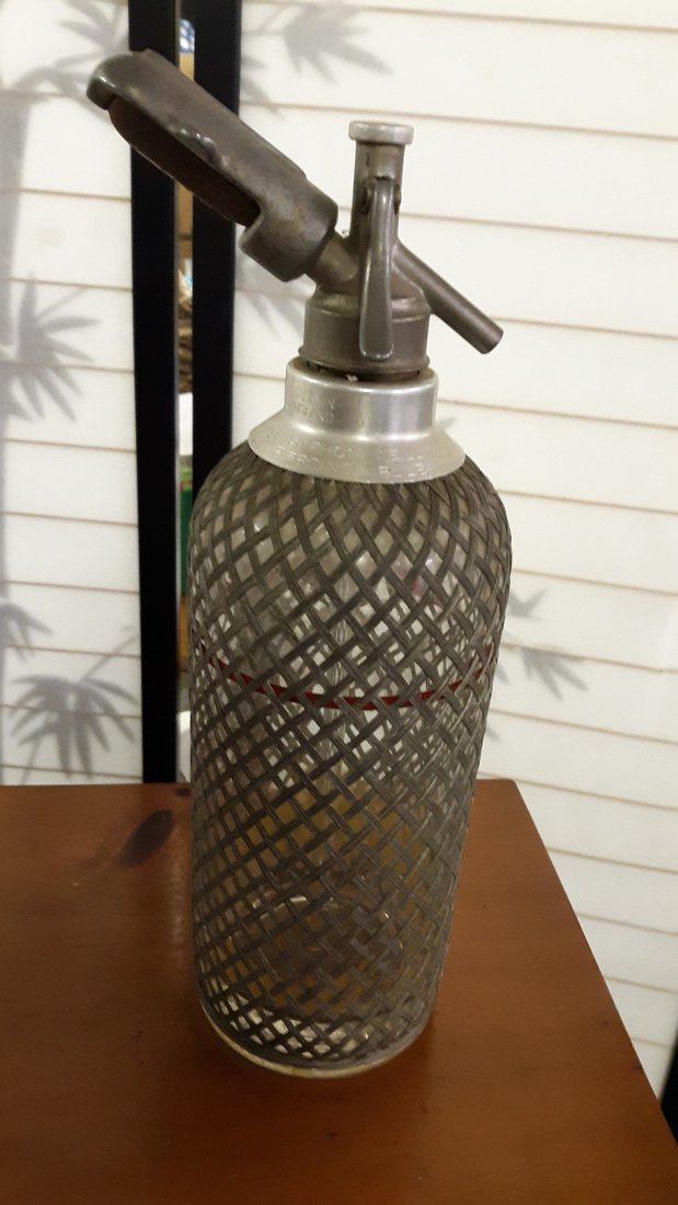Vintage sparklet soda syphon with with wire mesh: Vintage sparklet soda syphon with with wire meshCollectible and gorgeous for that mid century bar. The glass bottle is extremely heavy and sturdy for a bar cart or bar decor. Pewter can be polished to
