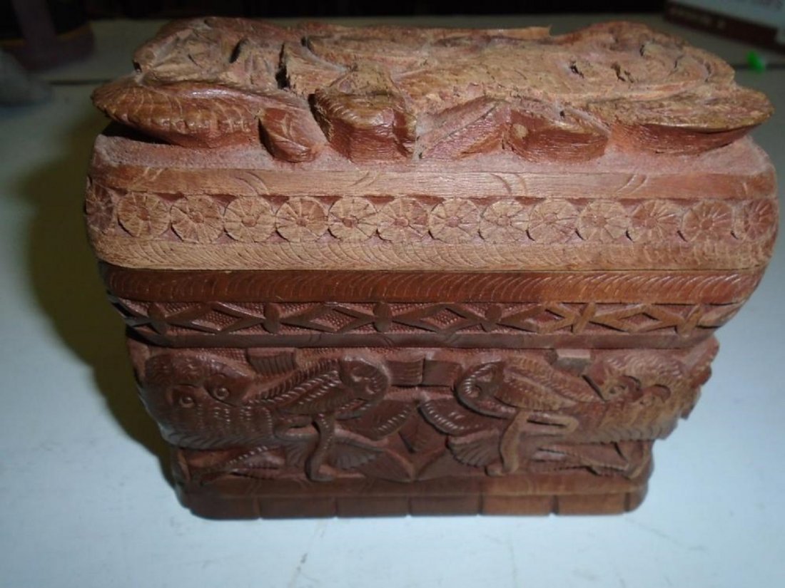 carved dragons ORIENTAL/ASIAN WOOD CIGARETTE BOX: VINTAGE WOOD CIGARETTE BOX carved dragons ORIENTAL/ASIAN open up and folds out to three seperate sections which can hold 40 cigarettes. in very good condition 4 1/2" tall 5 1/2" wide 3 " deep 1940's ?