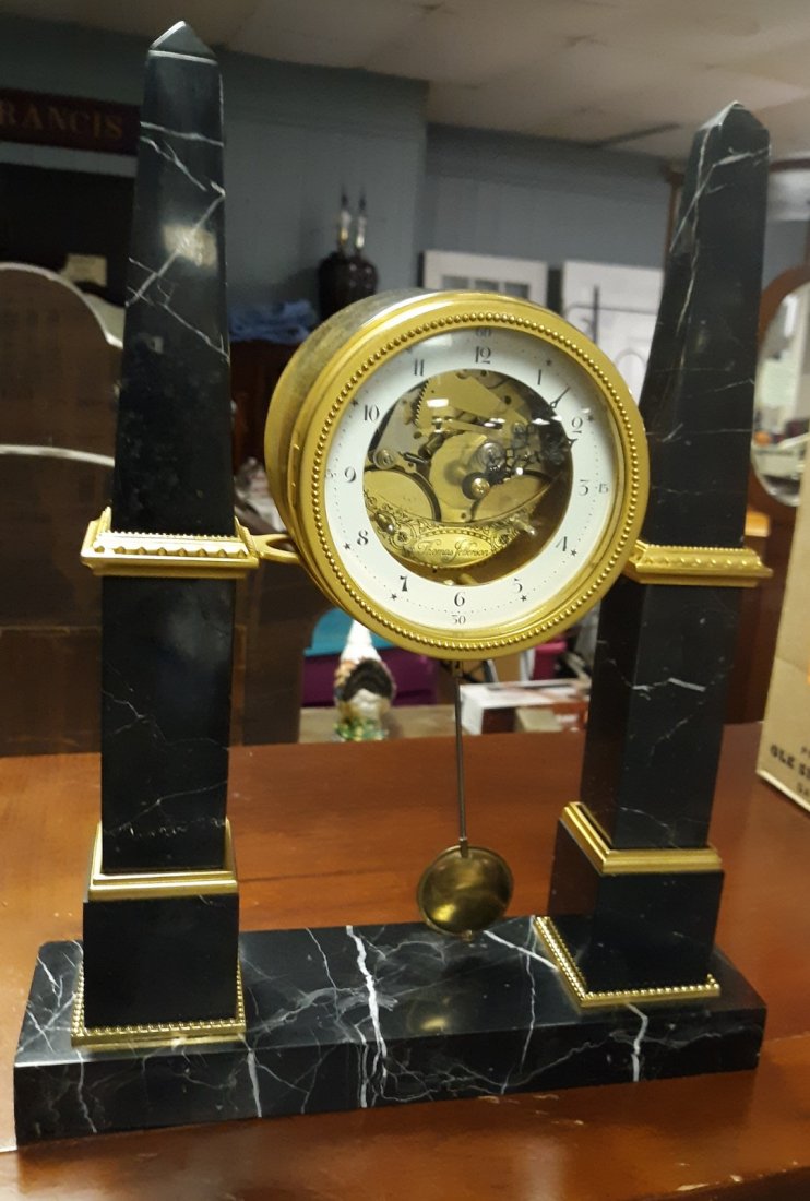 Jeffersons Monticello Obelisk Mantle Clock Franz Hermle: designed by Thomas Jefferson executed by louis chantrot designed back in 1791 this is a gorgeous redesign of that clock with marble obelisk columns open escapement movement made by Franz hermele thoma