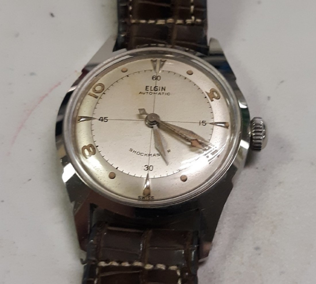 Gorgeous 1960's Elgin Automatic Mens Watch shock master: estate watch 2 tone face has light spotting noticed with loop, working great very clean case dura power shock master automatic original band leather is coming loose this is a gorgeous watch see pics !