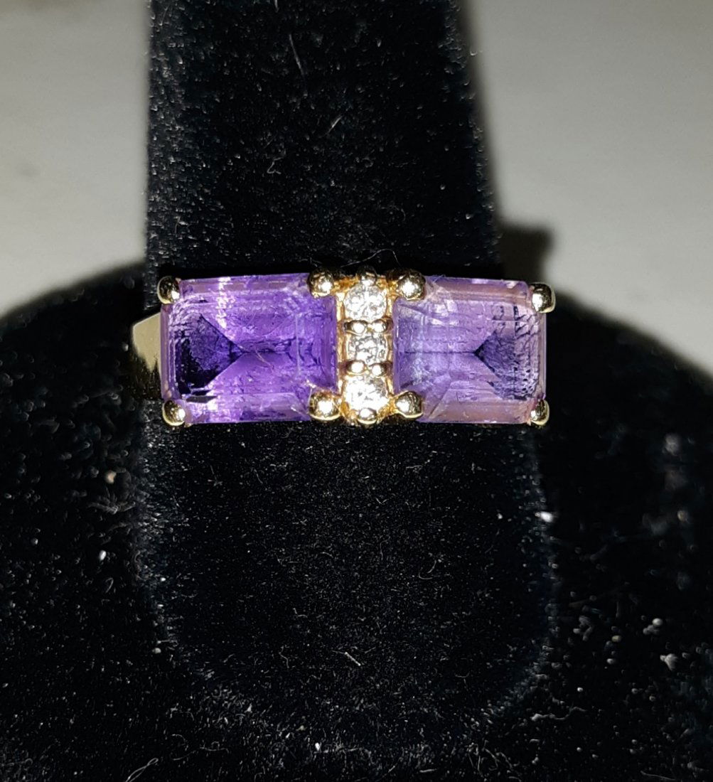 gorgeous 14K amethyst and diamond ring designer sz7 1/4: beautiful vintage ring with 2 appx 1 carat each emerald cut amethysts on each side and small diamonds in the center marked 14K with the designers marked HN in a circle see pics sz 7 1/4"