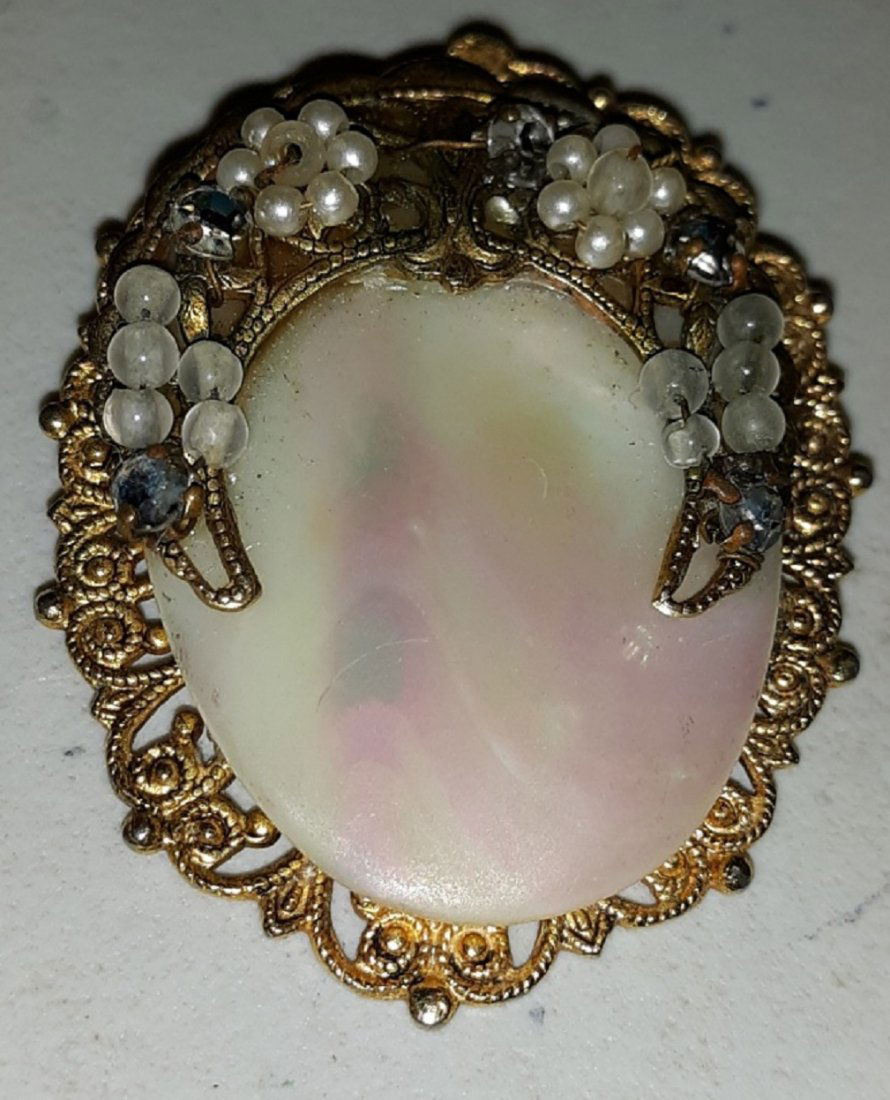 Antique Brooch MOP & gold filled w/rhinestones: gorgeous antique estate brooch gold filled? no markings that i can find. beautiful center MOP with rhinestones and white Jade? just stunning can be worn as a pin or put on your favorite chain! 1 7/8"