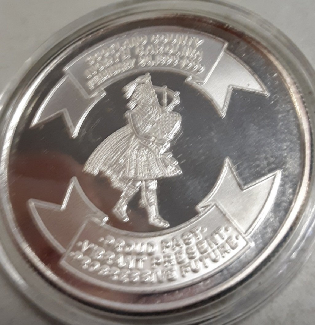 Scotland county NC Silver 1999 Bullion com coin 1 oz: from estate collection 1 oz silver comm round not marked for purity? looks like pure silver weighs 1 oz check out the pics