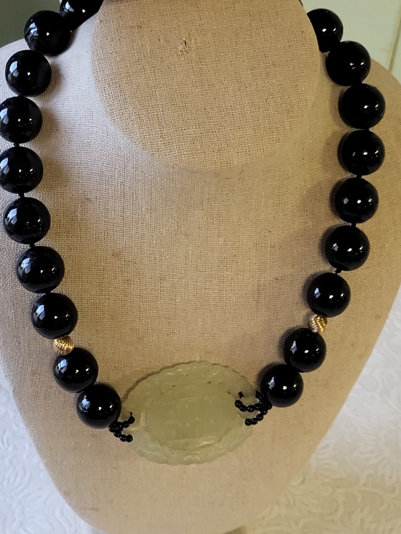 vtg jet black necklace w/green jade 28": unsigned could be worn either way green jade down or at the rear of the necklac 28" long very good seepics unsure if man made or natural seepics