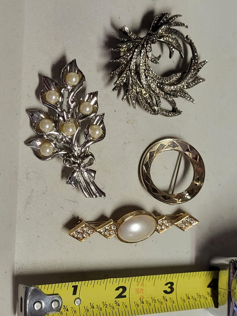 Lot Of 4 Pearl, Rhinestone + vintage brooches: lily brooch w/ faux pearls leaf brooch w/rhinestones geometric pin and lg pearl and rhinestones all 4 are nice and ready to wear see pics all 4 for one bid