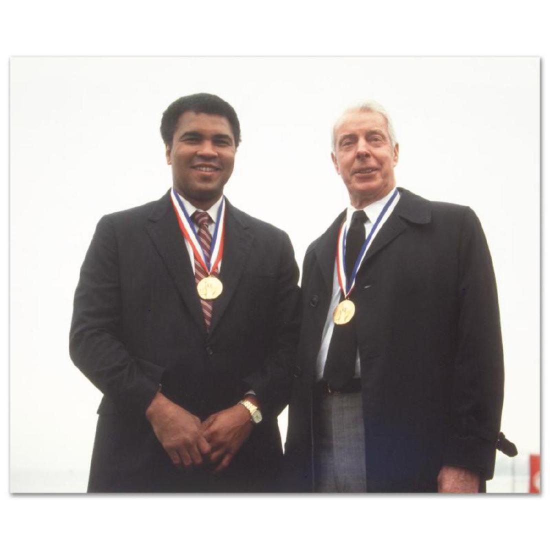 Licensed Photograph of Heavyweight Champ Muhammad Ali: Own a piece of sports history with this photograph of Muhammad Ali and Joe DiMaggio. Taken at the peak of his fame as one of the greatest heavyweight championship boxers of all time, this photo is sur