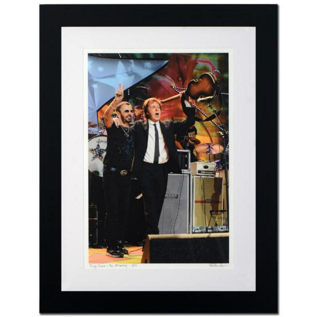 "Ringo Starr & Paul McCartney" Limited Edition Giclee: "Ringo Starr & Paul McCartney" is a limited edition giclee on paper, numbered and hand signed by acclaimed music industry photographer Rob Shanahan. This piece comes custom framed. Includes Certificat