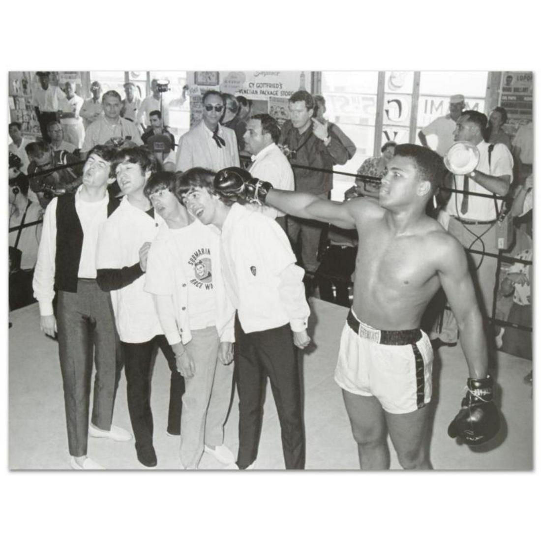"Muhammad Ali Punching The Beatles" Licensed Photograph: Own a piece of sports history with this Muhammad Ali and Beatles photo. Taken at the peak of his success as one of the greatest heavyweight championship boxers of all time, this photo is sure to compl