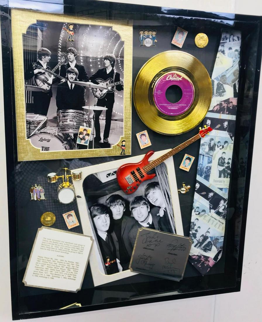 Beatles memorabilia Shadowbox: The Beatles memorabilia shadowbox framed with multiple collectible items such as pins, gold record, stamps, necktie, photos.. Frame Size: 20x30x3 inch
