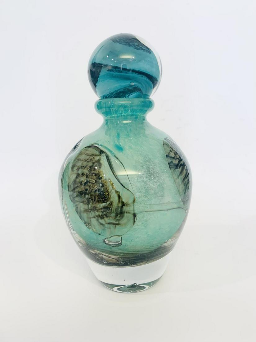 Jean Claude Novaro Green Perfume Bottle Hand blown glass: Artist: Jean Claude Novaro. Medium: Green Perfume Bottle Hand blown glass. Signature: Signed on bottom. Size: 8x5". Additional: This item has a crack internally refer to images , sold as is. Reference