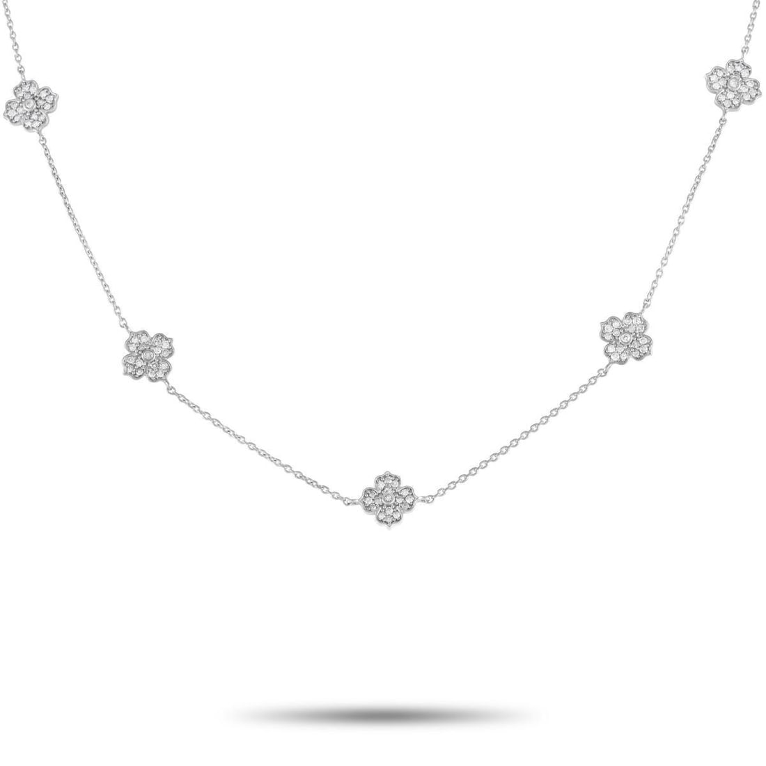 14K White Gold 0.50ct Diamond Flower Station Necklace: Rediscover your feminine confidence with this graceful diamond necklace. It features five four-petal blossom motifs set on stations along a thin chain in 14K white gold. Each floral frame is detailed 