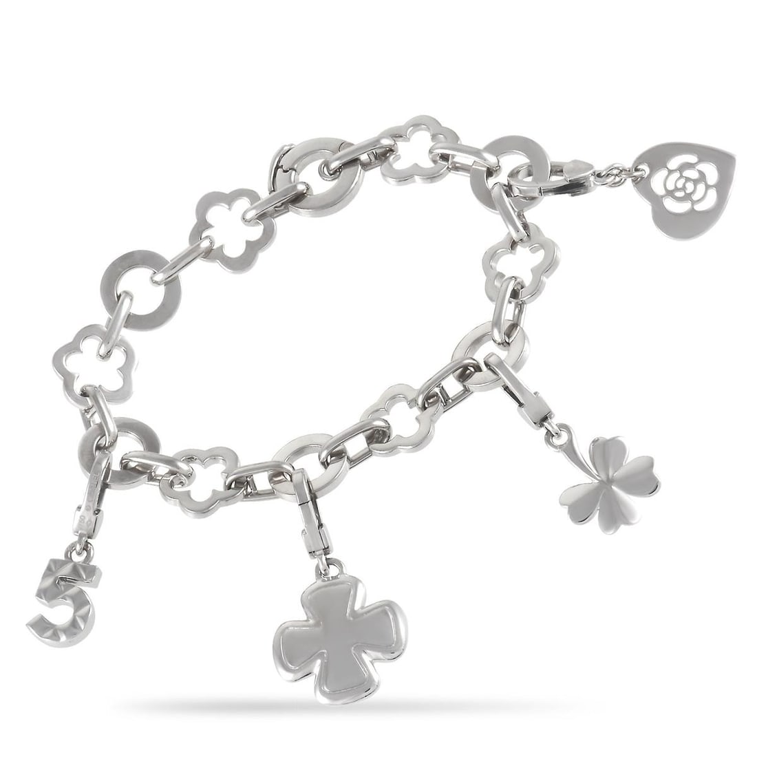 CHANEL CAMELIA 18K WHITE GOLD FOUR CHARM BRACELET: The Chanel charm bracelet is a dream. The bracelet is made up of alternating floral and round links. The bracelet features four dangling charms over its length, including two four-leaf clovers, a 5 ch