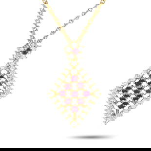 18K YELLOW GOLD 0.55CT DIAMOND AND RUBY NECKLACE: An effortlessly alluring piece with a fresh, geometric design. This yellow gold necklace features a fine chain with a secure spring ring fastener. It has a diamond-shaped pendant outlined with tiny wh