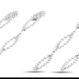 18K WHITE GOLD 1.0CT DIAMOND DROP EARRINGS: Curved, pointed, and sparkly, these earrings feature a conservative style with a hint of geometric flair. Each earring has a trio of football-shaped frames, elegantly detailed with petite round diamon