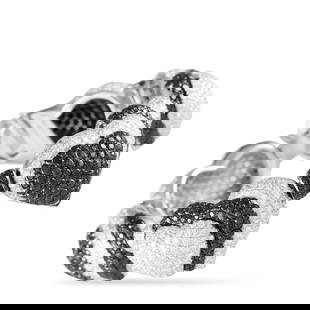 DE GRISOGONO 18K WHITE GOLD 21.70CT DIAMOND BLACK AND WHITE HEARTS BRACELET: Showy, shapely, and stunning, this remarkable bracelet by de Grisogono impresses with its 21.70 carats of black and white diamonds. The white gold bracelet features diamond-studded domed hearts linked