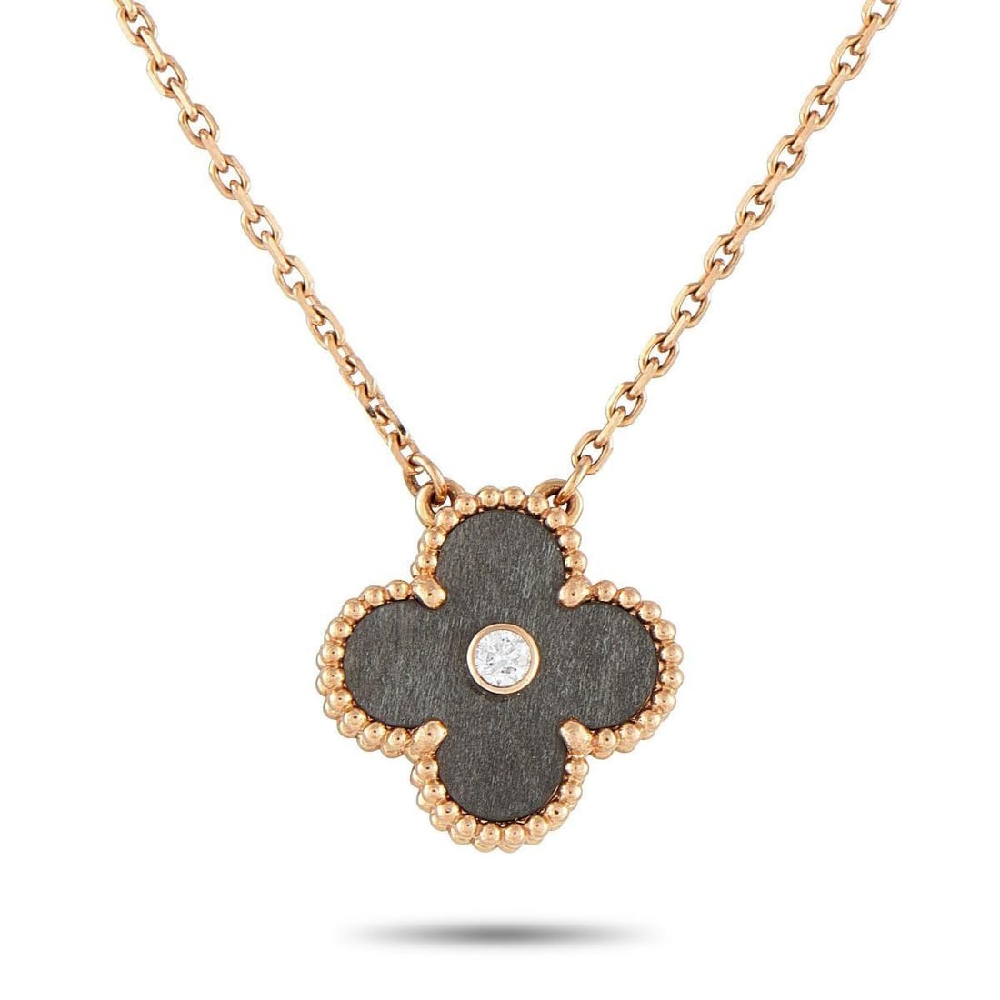VAN CLEEF & ARPELS ALHAMBRA 18K ROSE GOLD DIAMOND HOLIDAY PENDANT NECKLACE: This Van Cleef & Arpels Holiday Alhambra necklace is the perfect piece for collectors or anyone who appreciates timeless luxury. A dark gray stone surrounds a single Diamond at the center of the iconi