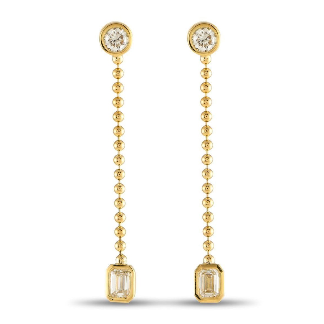 18K YELLOW GOLD 1.40CT DIAMOND DANGLE EARRINGS: These earrings are designed to continually capture your imagination. Round cut Diamonds and emerald cut Diamonds with a total weight of 1.40 carats bookend the dramatic design. At the center, a beaded