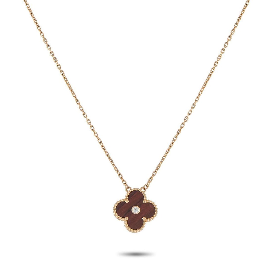 VAN CLEEF & ARPELS ALHAMBRA 18K ROSE GOLD DIAMOND AND BULLS EYE HOLIDAY PENDANT NECKLACE: Effortless to wear and instantly recognizable, this Van Cleef & Arpels necklace stands as the perfect example of refined simplicity. It features the classic Alhambra four-leaf-clover motif as its pend