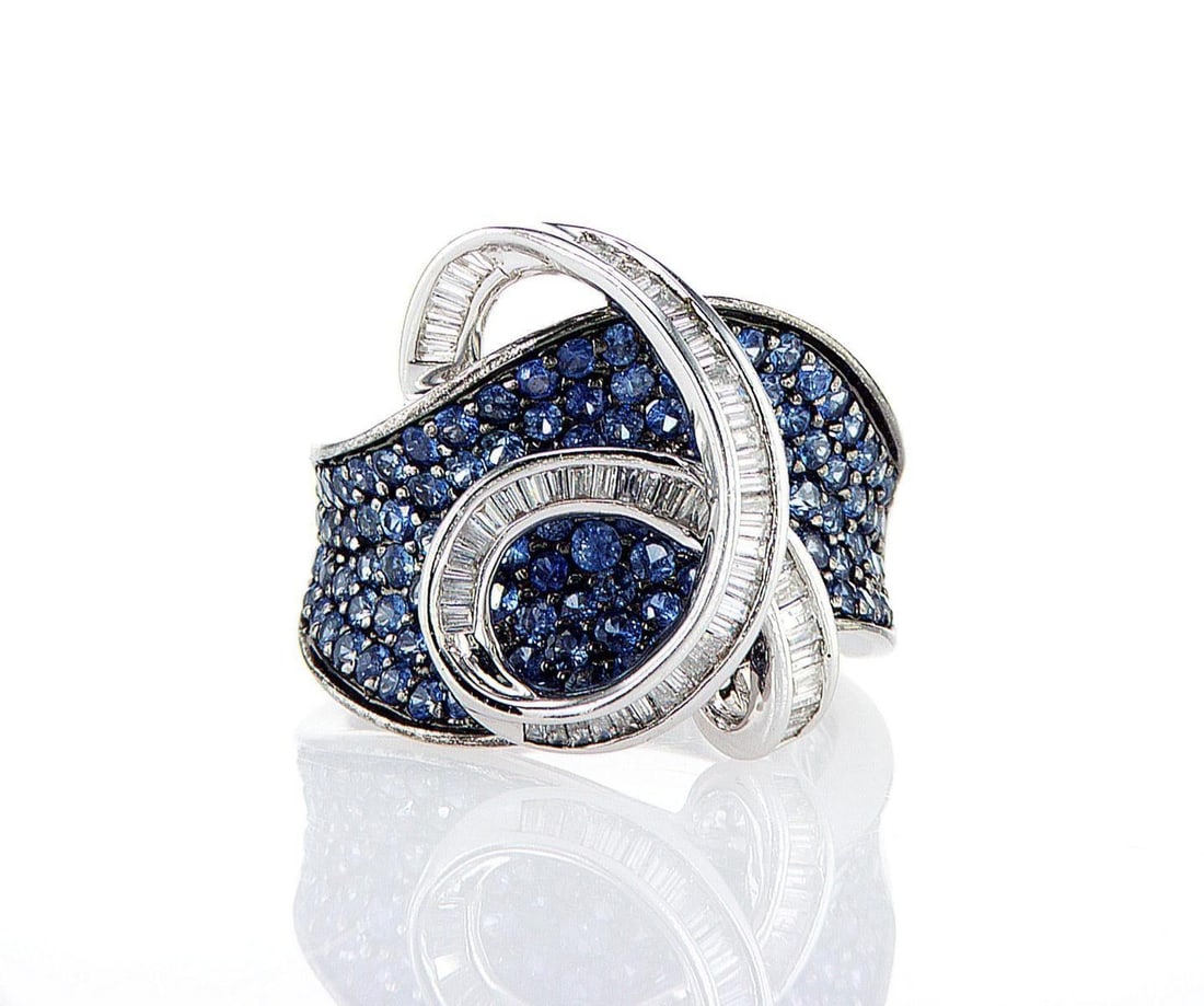 18kt White Gold 2.74ctw Diamond Ring: One 18k white gold ring, set with natural diamond. Jewelry Weight: 13.22Grs Total Diamonds Weight: 2.74Cts Main Stones Description: Quantity: 60 Cut and shape: Baguette Carats Weight: 0.54 Clarity: VS