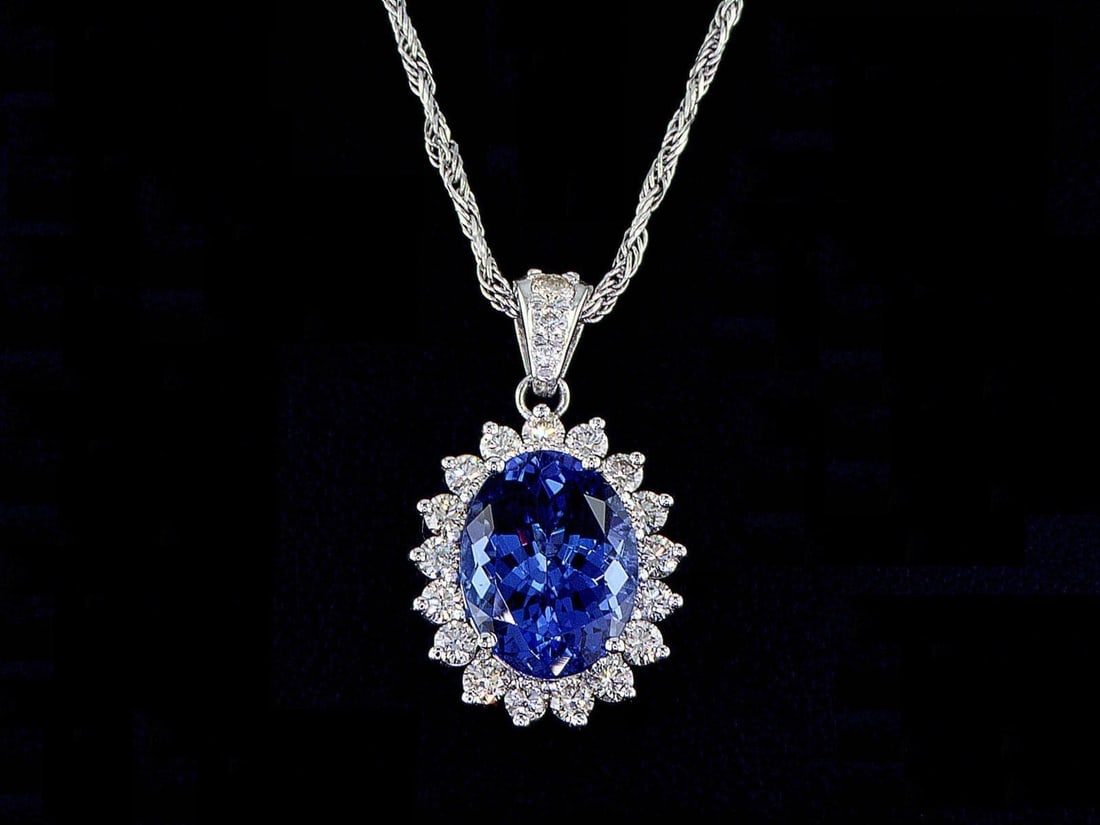 14kt White Gold 0.88ctw Diamond Pendant: One 14k white gold pendant (585 stamped), set with one center tanzanite and natural diamonds around. Natural diamonds description: Cut and shape: Round Brilliant. Total Weight: 0.88 cts. Cut/Polish/Sy