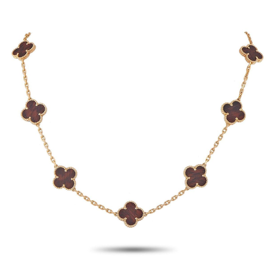 VAN CLEEF & ARPELS VINTAGE ALHAMBRA 18K ROSE GOLD LETTERWOOD 10-MOTIF NECKLACE: This Van Cleef & Arpels Alhambra necklace offers an elevated take on one of the luxury brands most iconic motifs. Each one of the 10 clover-shaped motifs is accented with Letterwood a precious wood fr