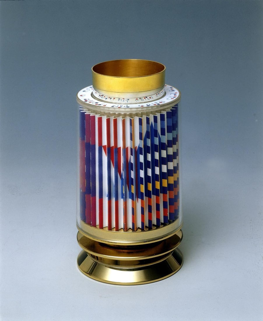 Yaacov Agam- Kiddush Cup: Artist: Yaacov Agam. Medium: Kiddush Cup. Size: 6" x 3". Signature: Hand Signed and Numbered by the artist. Additional: 24k gold plated sterling silver with agamograph in lucite.Edition of 1800.