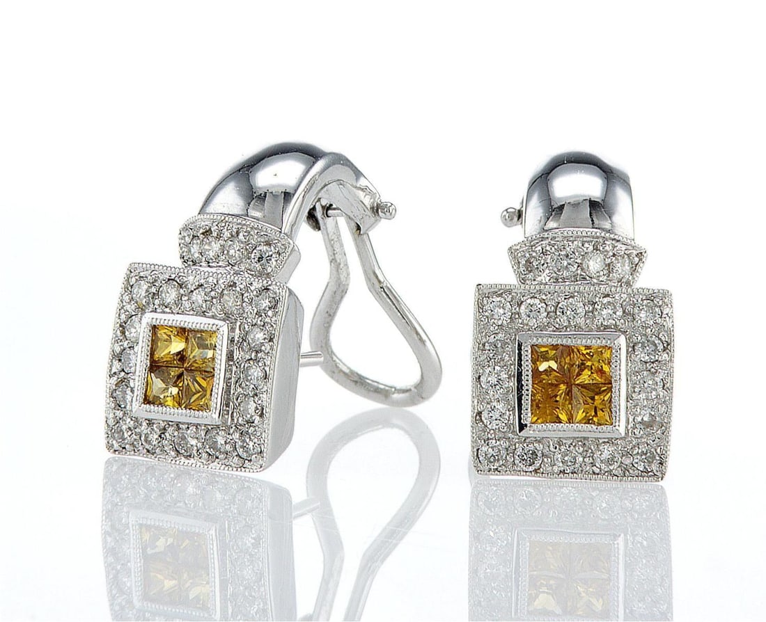 18kt White Gold 0.58ctw Diamond Earrings: One pair of 18k white gold earrings, each set with one center natural sapphires and natural diamonds around and on the sides. Jewelry Weight: 8.69Grs Total Diamonds Weight: 0.58Cts Main Stones Descrip