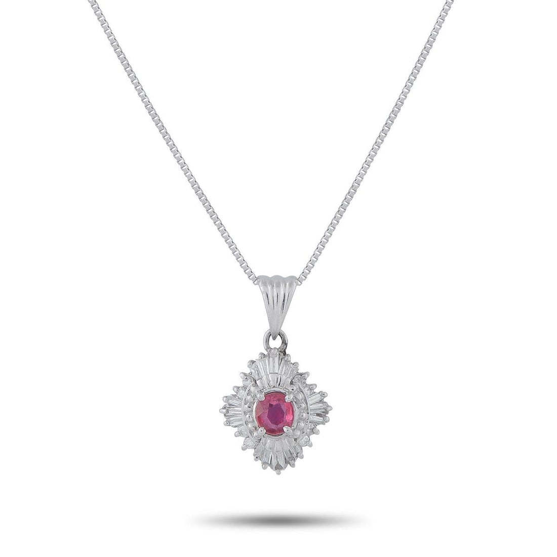 PLATINUM 0.34CT DIAMOND AND RUBY PENDANT NECKLACE: An piece offering a quiet nod to another era. Suspended from a box chain necklace is an oval ruby framed by a ballerina-style halo. The setting recalls mid-century design, where symmetry and light wer