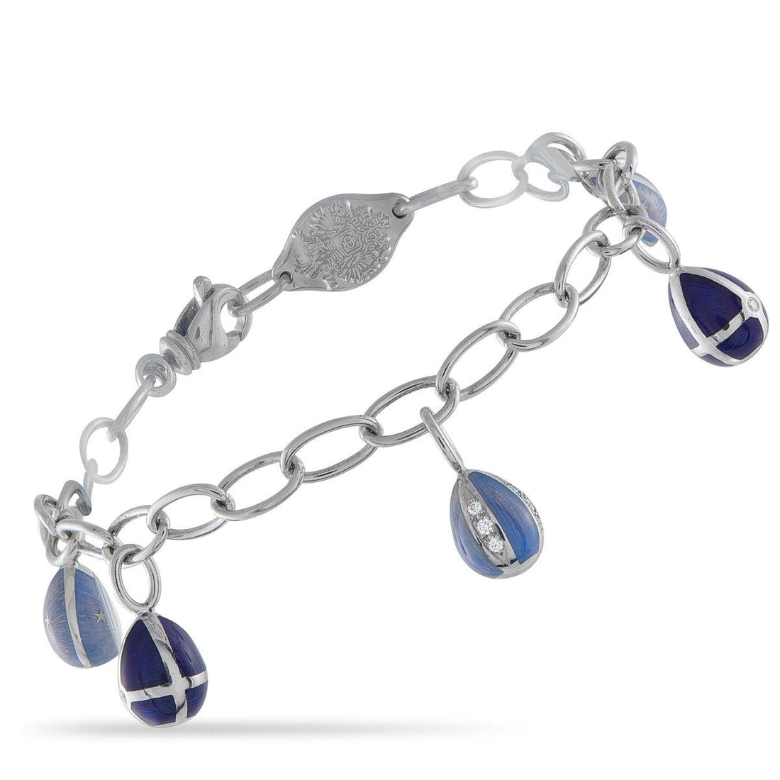 FABERGE 18K WHITE GOLD DIAMOND AND BLUE ENAMEL EGG CHARM BRACELET: This Faberg Egg Charm bracelet offers a playful reinterpretation of one of the luxury brands most iconic symbols. Suspended from this pieces 18K White Gold chain are series of miniature Faberg eggs el