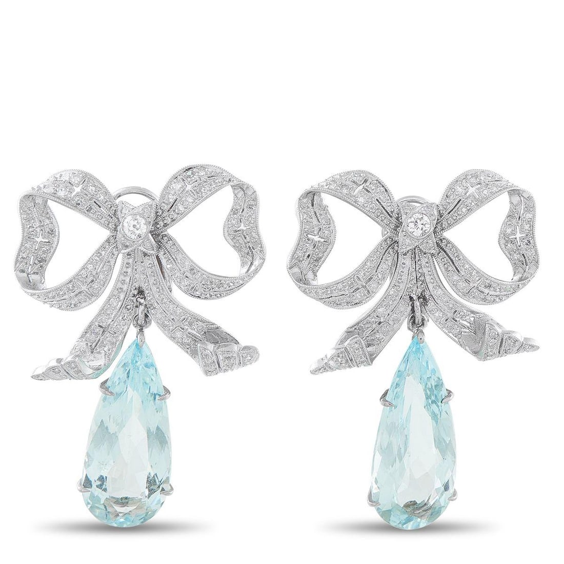 PLATINUM 0.50CT DIAMOND AND AQUAMARINE BOW EARRINGS: A ladylike design makes these luxury earrings endlessly impressive. Featuring Diamonds with a total weight of 0.50 carats, the bow motif will instantly add charm and sophistication to any ensemble. Da