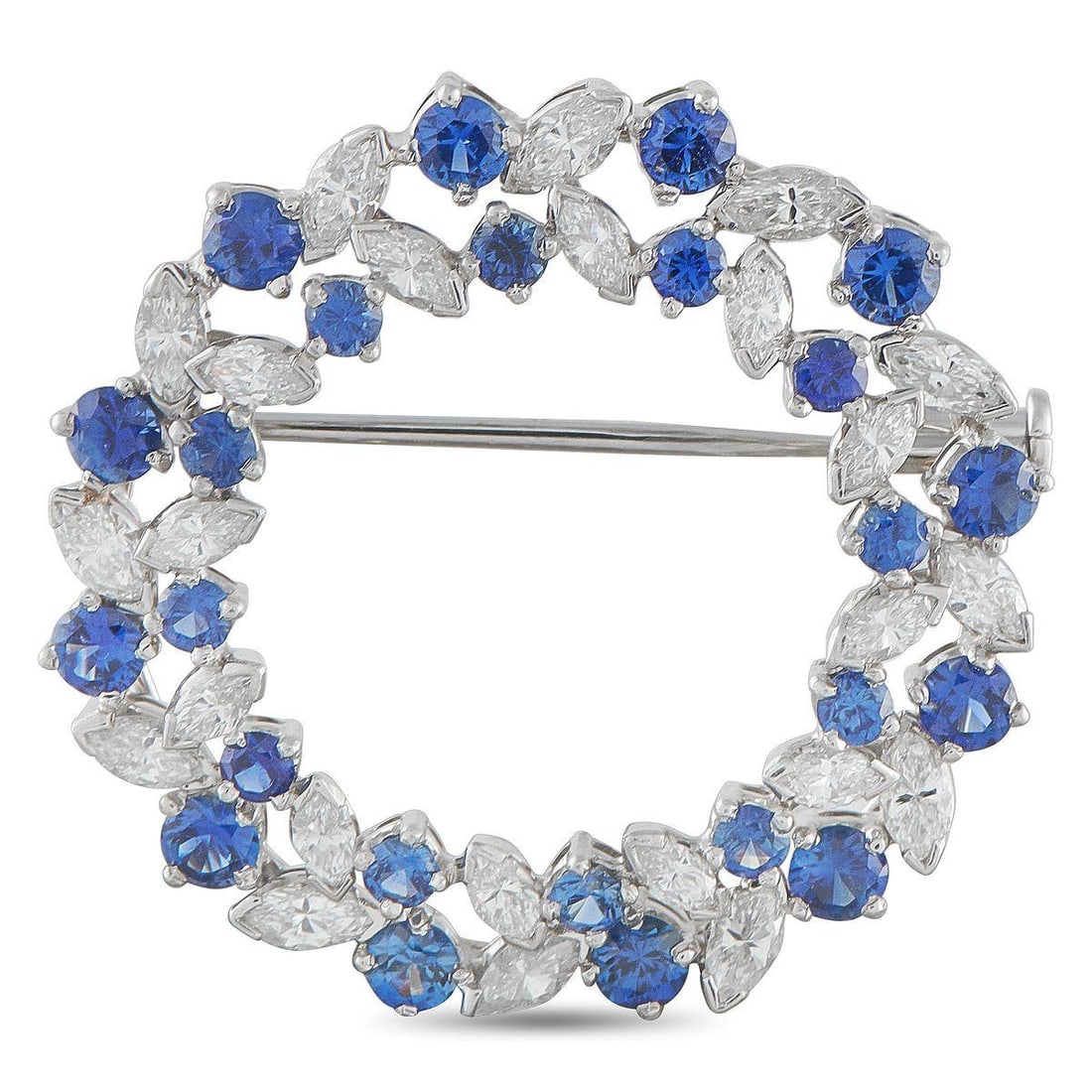 OSCAR HEYMAN PLATINUM 1.70CT DIAMOND AND SAPPHIRE CIRCLE BROOCH: Round. Regal. Radiant. This Oscar Heyman brooch is shaped like a refined wreath in platinum. Marquise diamonds sit with half bezels at each pointed end, alternating with round blue sapphires in varyin