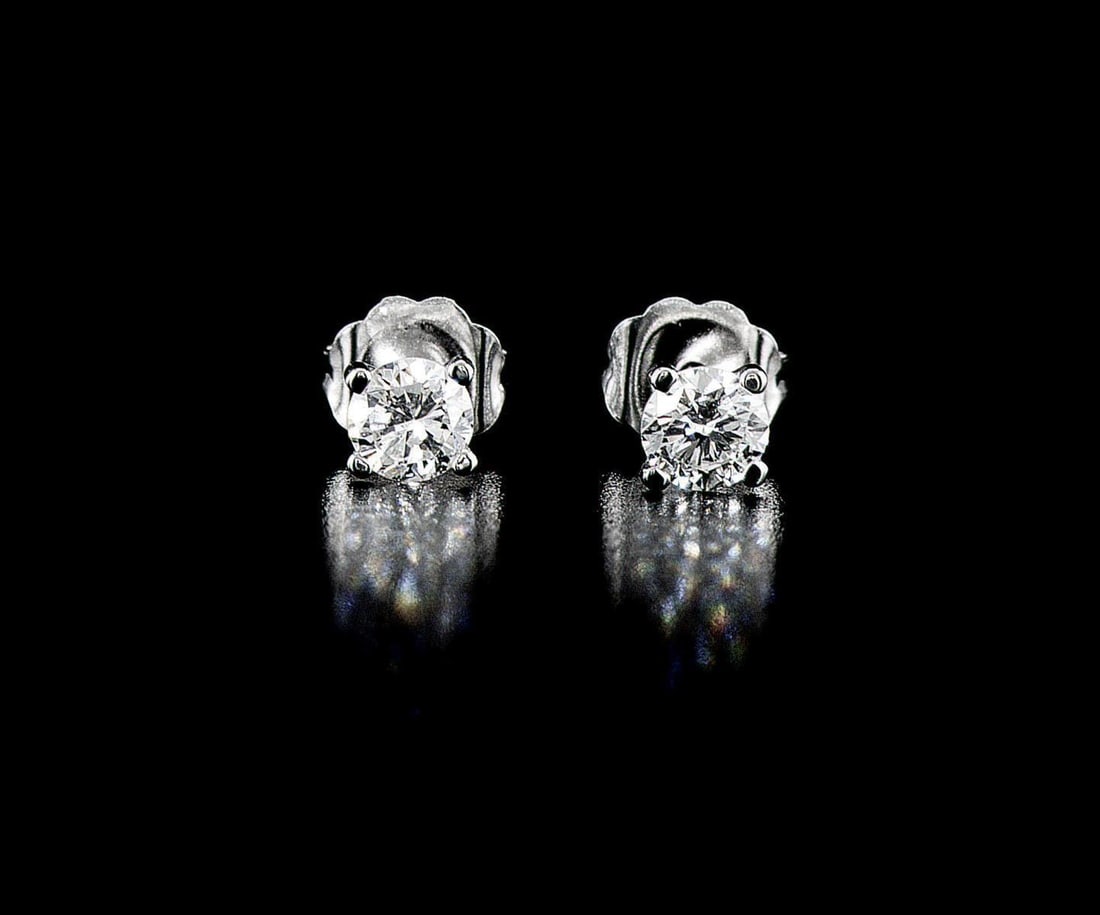 14kt White Gold 0.52ctw Diamond Earrings: One pair of 14k white gold earrings, each set with one natural diamond. Jewelry Weight: 0.72Grs Total Diamonds Weight: 0.52Cts Main Stones Description: Quantity: 2 Cut and shape: Round Brilliant Carat