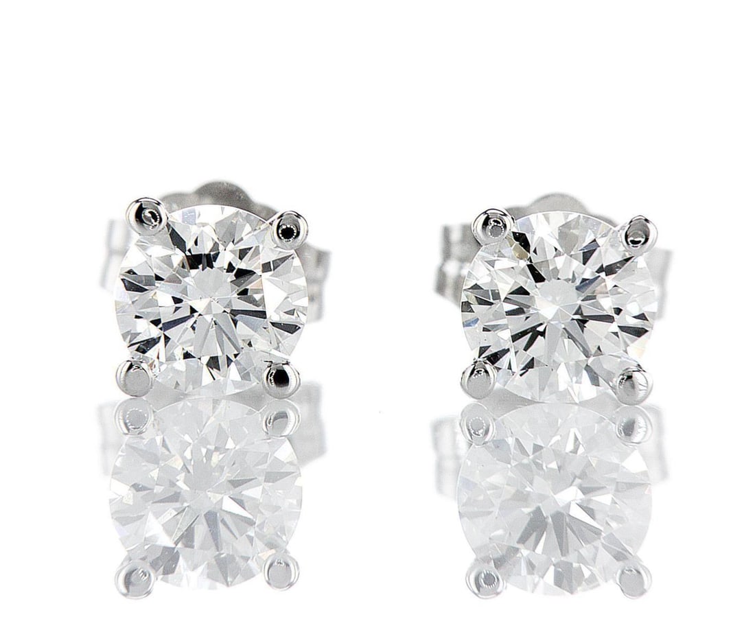 14kt White Gold 1ctw Diamond Earrings: One pair of 14k white gold earrings, each set with one natural diamond Jewelry Weight: 0.82Grs Total Diamonds Weight: 1Cts Main Stones Description: Quantity: 1 Cut and shape: Round Brilliant Carats We