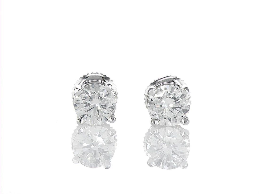 18kt White Gold 1.4ctw Diamond Earrings: One pair of 18k white gold earrings (18k stamped), each set with one natural diamond. Jewelry Weight: 3.57Grs Total Diamonds Weight: 1.4Cts Main Stones Description: Quantity: 2 Cut and shape: Round Br